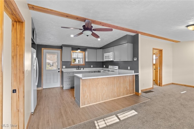 kitchen with a textured ceiling, white appliances, gray cabinets, and ceiling fan