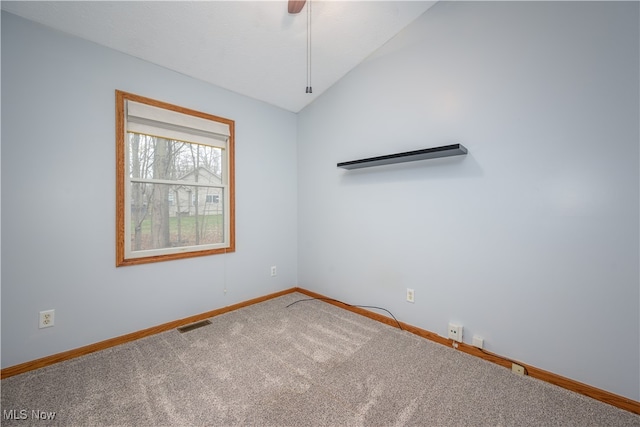 unfurnished room featuring carpet flooring, ceiling fan, and vaulted ceiling