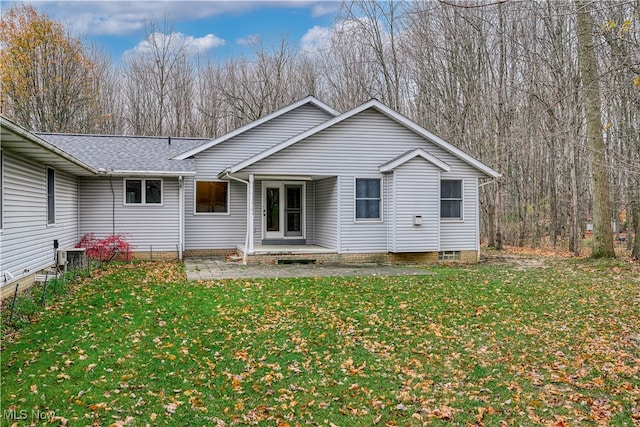 back of house featuring a yard and central AC unit