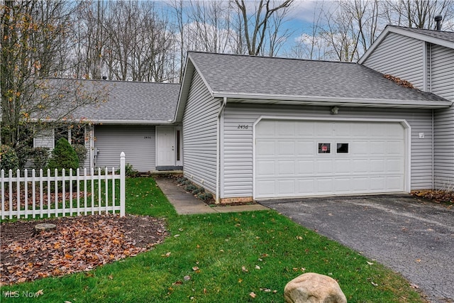 exterior space featuring a garage and a front lawn