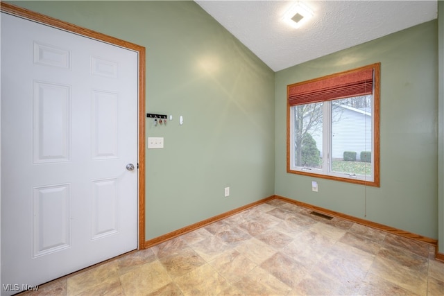 empty room featuring a textured ceiling