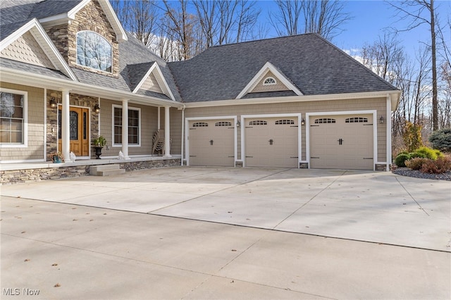 craftsman-style home featuring covered porch and a garage