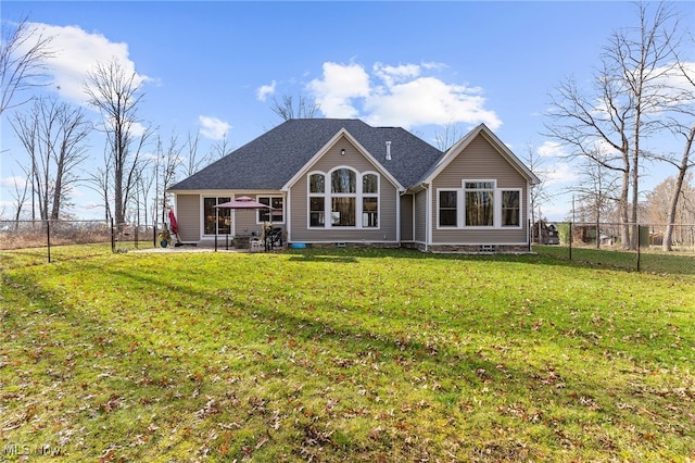 rear view of house with a lawn and a patio area