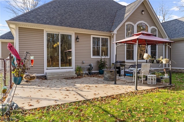 rear view of property with a gazebo and a patio