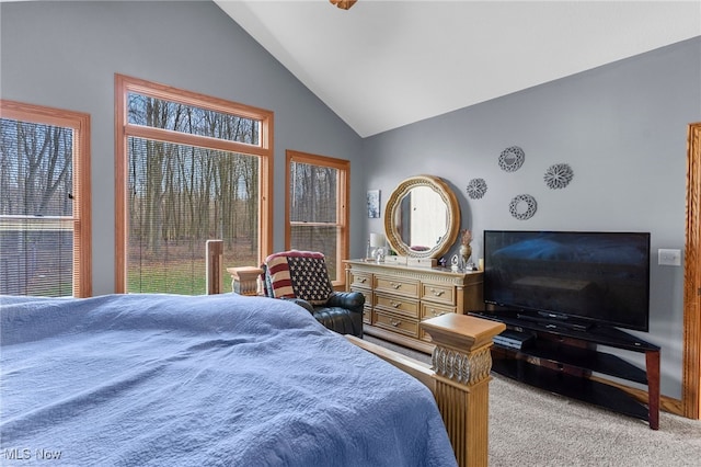 carpeted bedroom featuring high vaulted ceiling