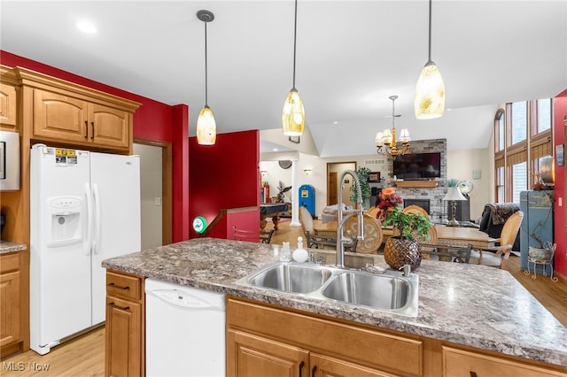 kitchen with a fireplace, white appliances, light hardwood / wood-style flooring, and sink