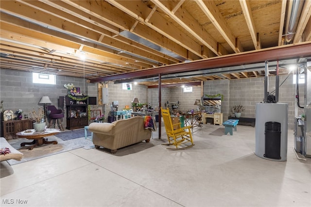 basement featuring electric panel and water heater