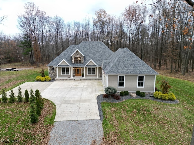 view of front of property featuring covered porch and a front lawn