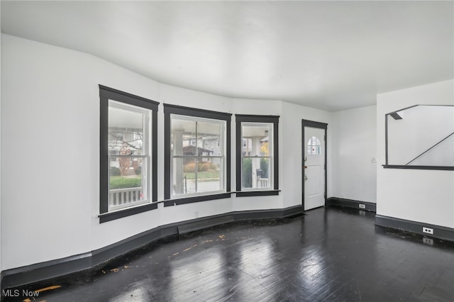 empty room featuring dark hardwood / wood-style flooring