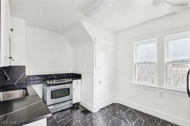 kitchen with stainless steel electric stove, white cabinets, and sink