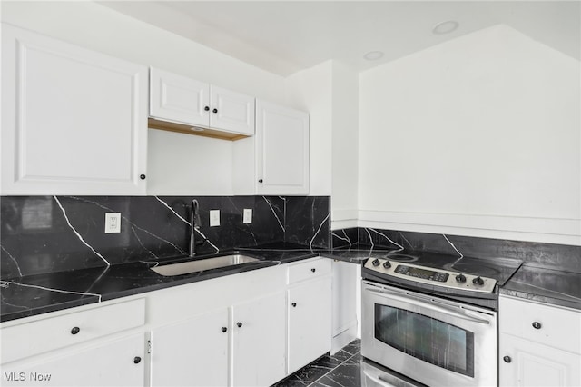 kitchen featuring tasteful backsplash, white cabinetry, stainless steel range with electric stovetop, and sink