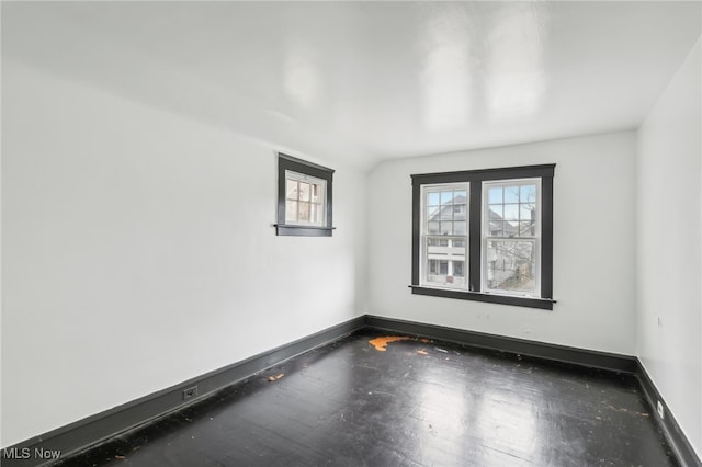 spare room featuring lofted ceiling