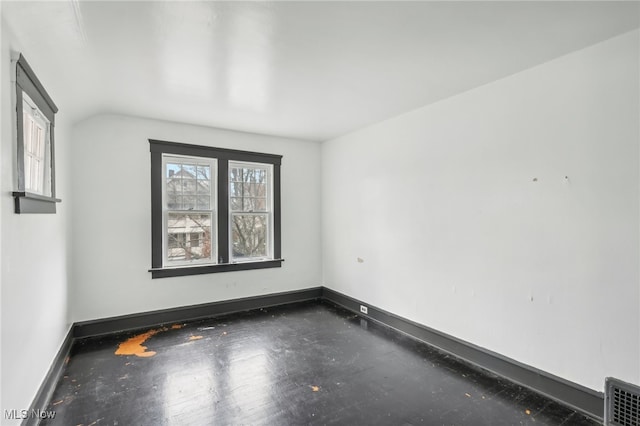 empty room with vaulted ceiling