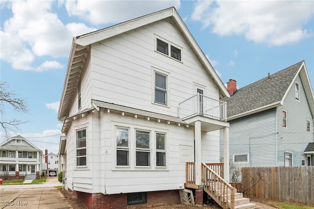 rear view of property with a balcony