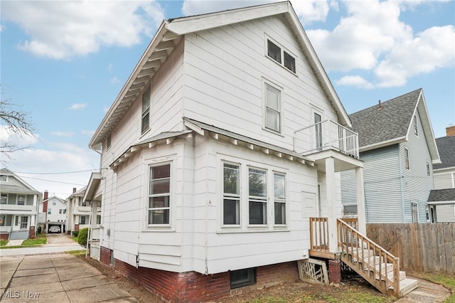 back of property featuring a balcony