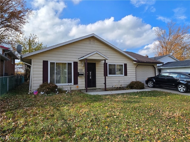 view of front of home featuring a front yard and a garage