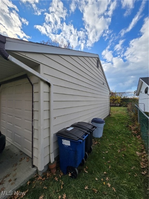 view of home's exterior with a lawn and a garage