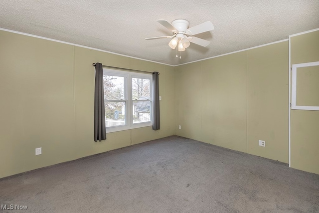 unfurnished room with ceiling fan, light colored carpet, ornamental molding, and a textured ceiling