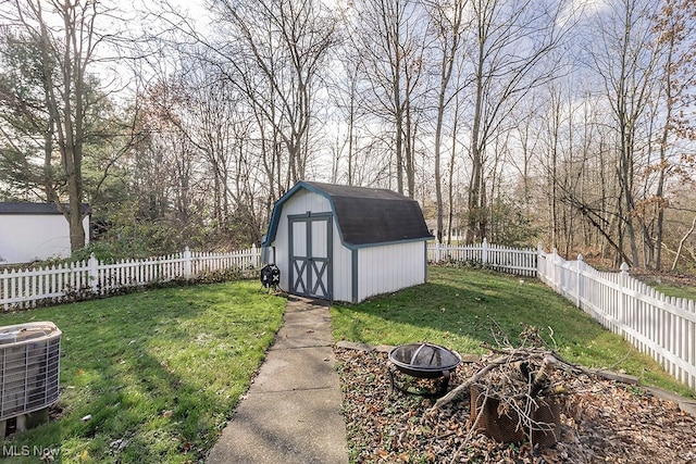 view of yard featuring a fire pit and central AC