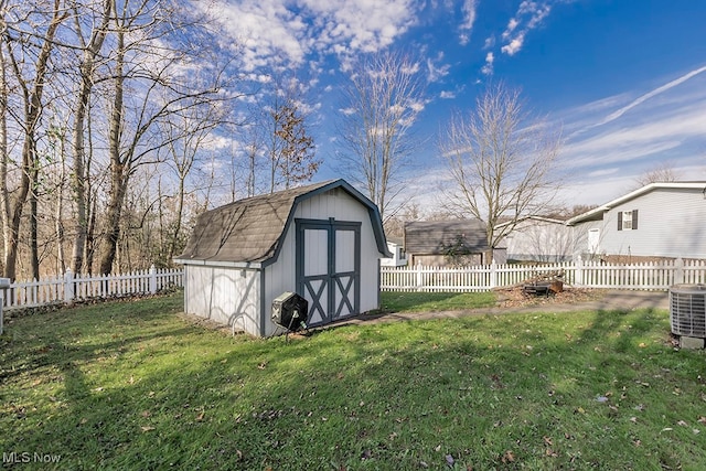 view of yard featuring a shed and central air condition unit