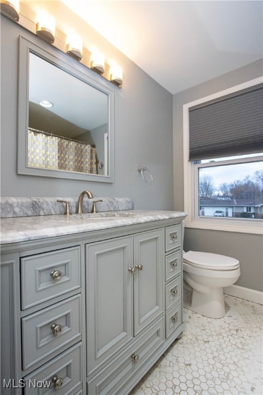 bathroom with tile patterned floors, vanity, and toilet