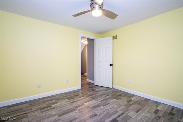 empty room with hardwood / wood-style flooring and ceiling fan