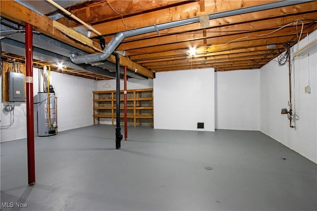 basement featuring electric panel and water heater