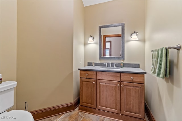 bathroom featuring vanity and toilet