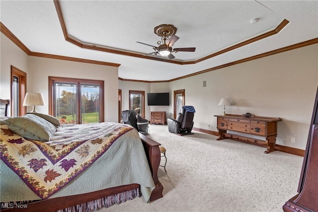 bedroom featuring a raised ceiling, ceiling fan, light carpet, and ornamental molding