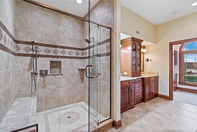 bathroom featuring tile patterned floors, vanity, and walk in shower