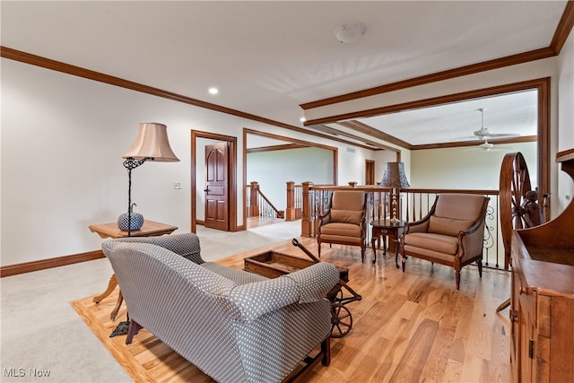 living room featuring light hardwood / wood-style floors, ceiling fan, and ornamental molding