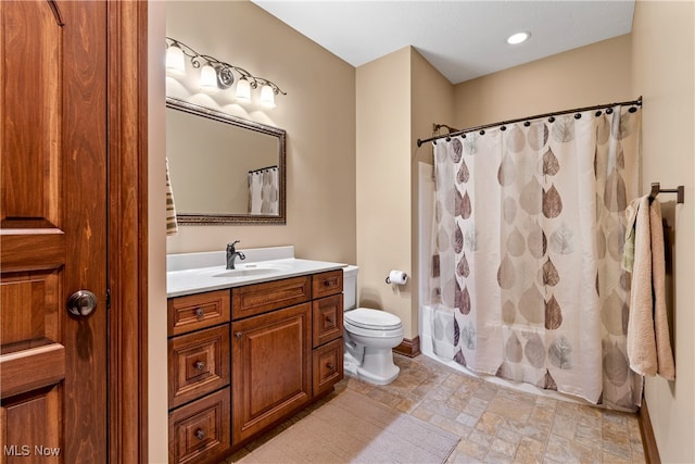 full bathroom featuring shower / bathtub combination with curtain, vanity, and toilet