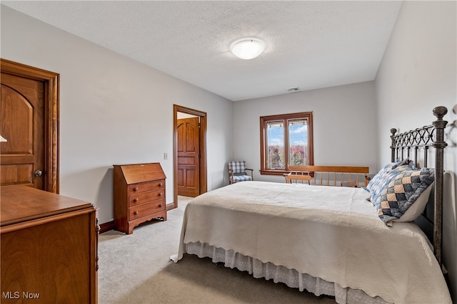 carpeted bedroom with a textured ceiling