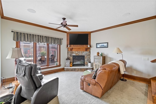 carpeted living room featuring crown molding, a fireplace, ceiling fan, and a textured ceiling