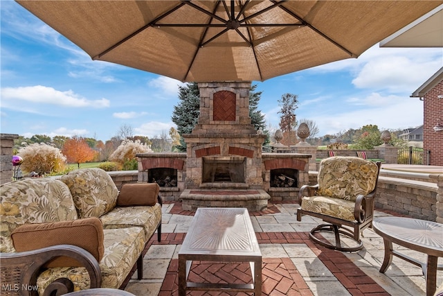 view of patio / terrace with an outdoor living space with a fireplace