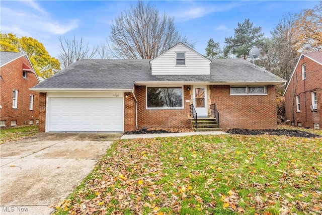 view of front of house with a front yard and a garage