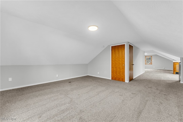 bonus room featuring carpet flooring and vaulted ceiling