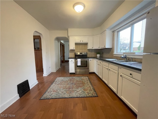 kitchen featuring white cabinetry, sink, and stainless steel range with electric cooktop