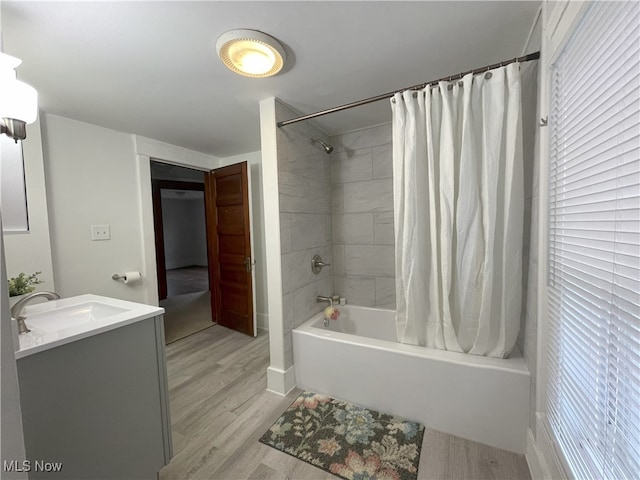 bathroom featuring vanity, hardwood / wood-style flooring, and shower / bath combo with shower curtain