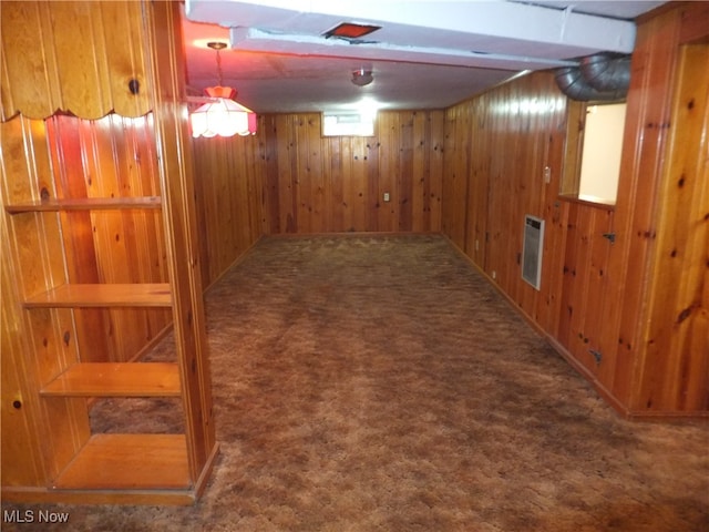 basement with wood walls and dark carpet