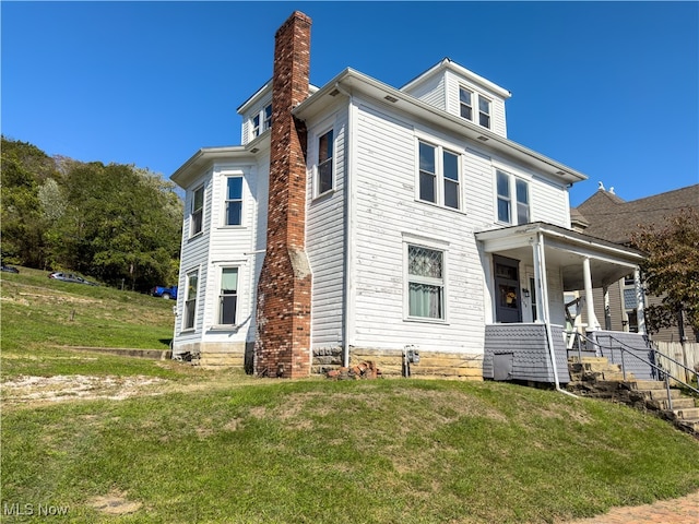 exterior space with a porch and a front yard