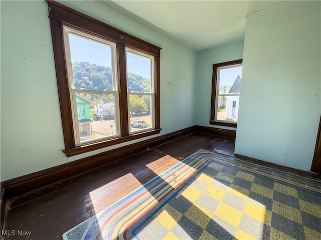 spare room featuring dark hardwood / wood-style floors