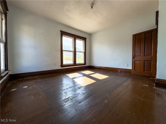 empty room featuring dark wood-type flooring