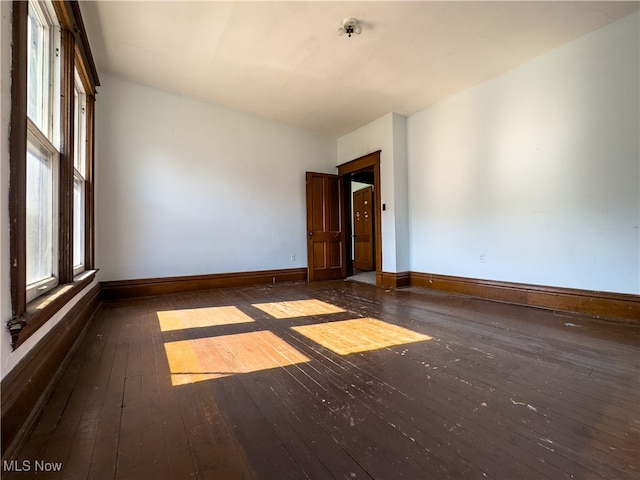 unfurnished room featuring dark wood-type flooring