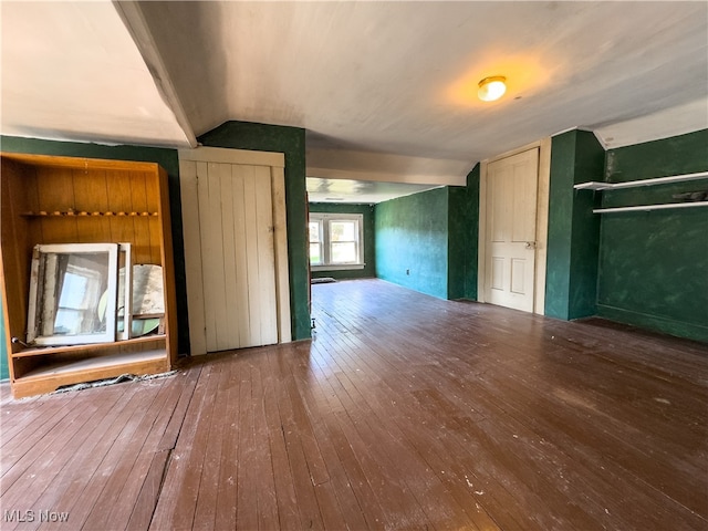 interior space with wood-type flooring and vaulted ceiling