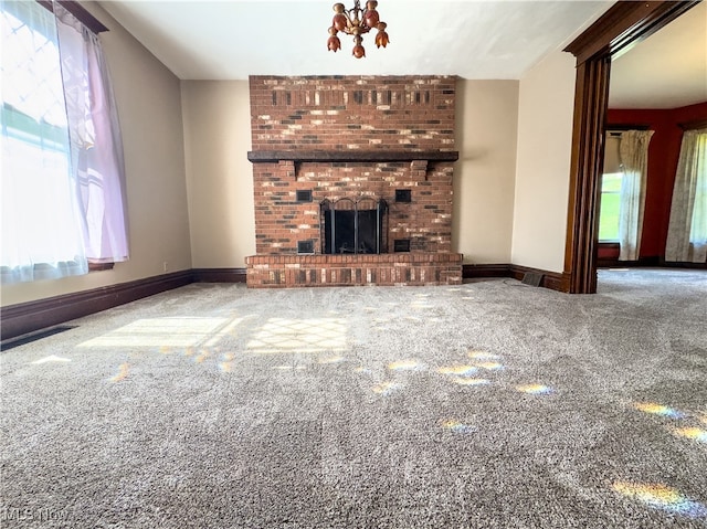 unfurnished living room with carpet floors and a brick fireplace