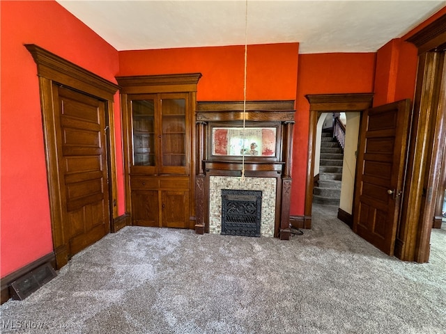 unfurnished living room with dark colored carpet