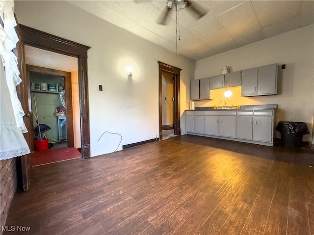 interior space featuring dark hardwood / wood-style floors, gray cabinets, sink, and ceiling fan