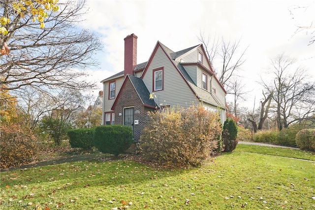 view of side of property with a yard