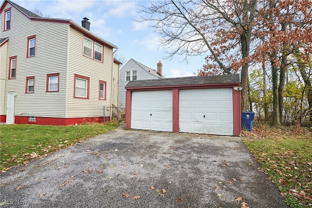 exterior space with an outbuilding and a garage